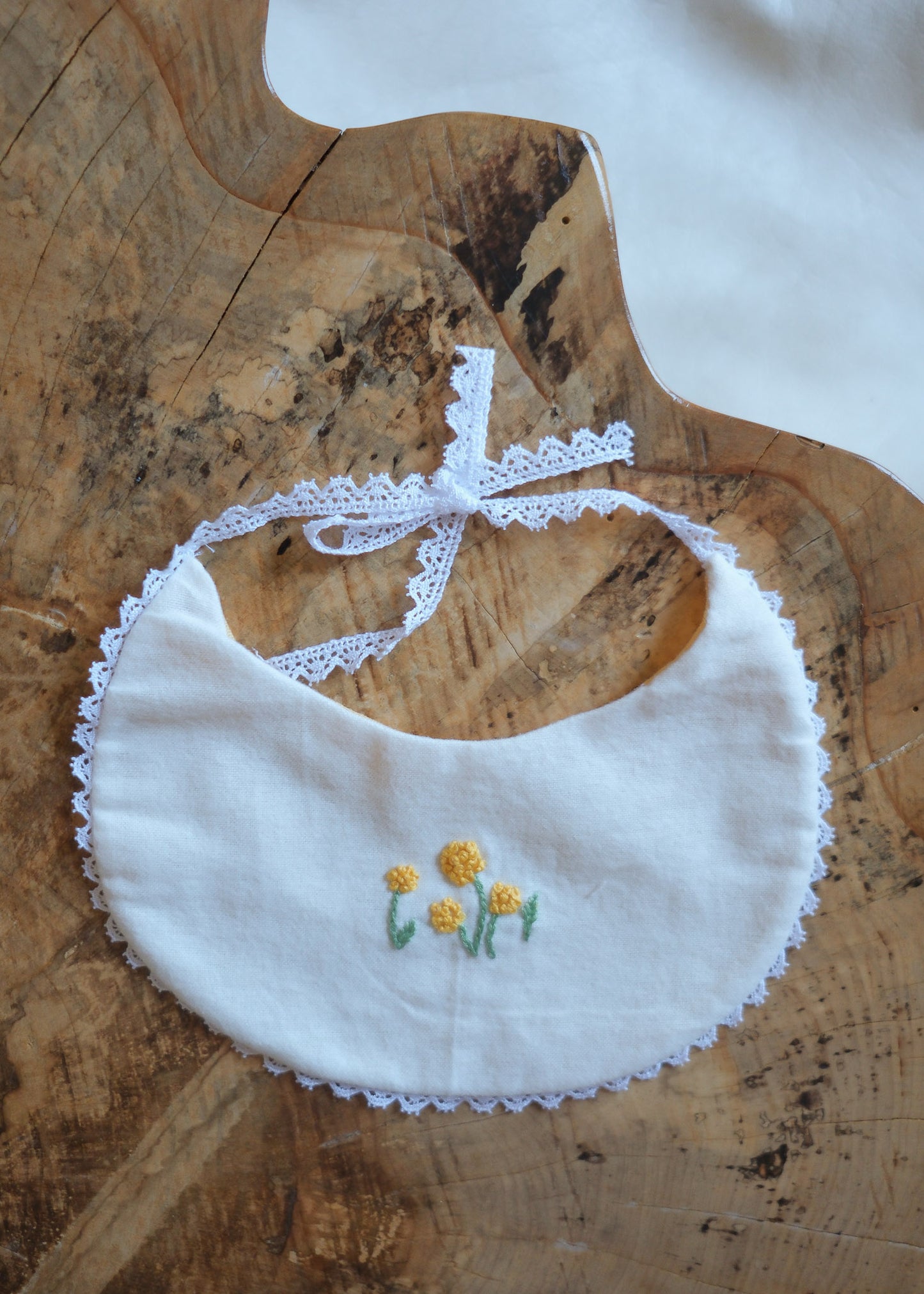 White Bib with Embroidered Yellow Flowers