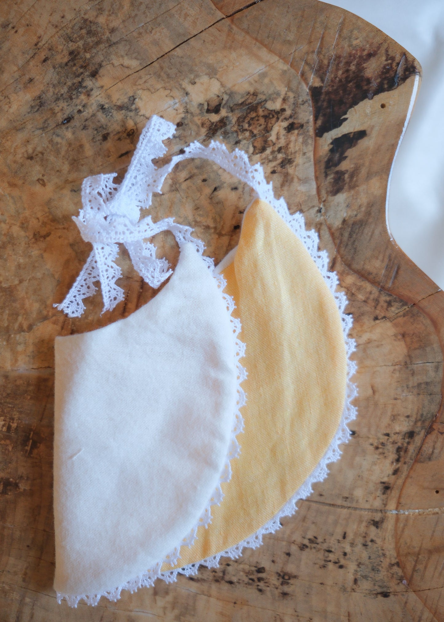 White Bib with Embroidered Yellow Flowers