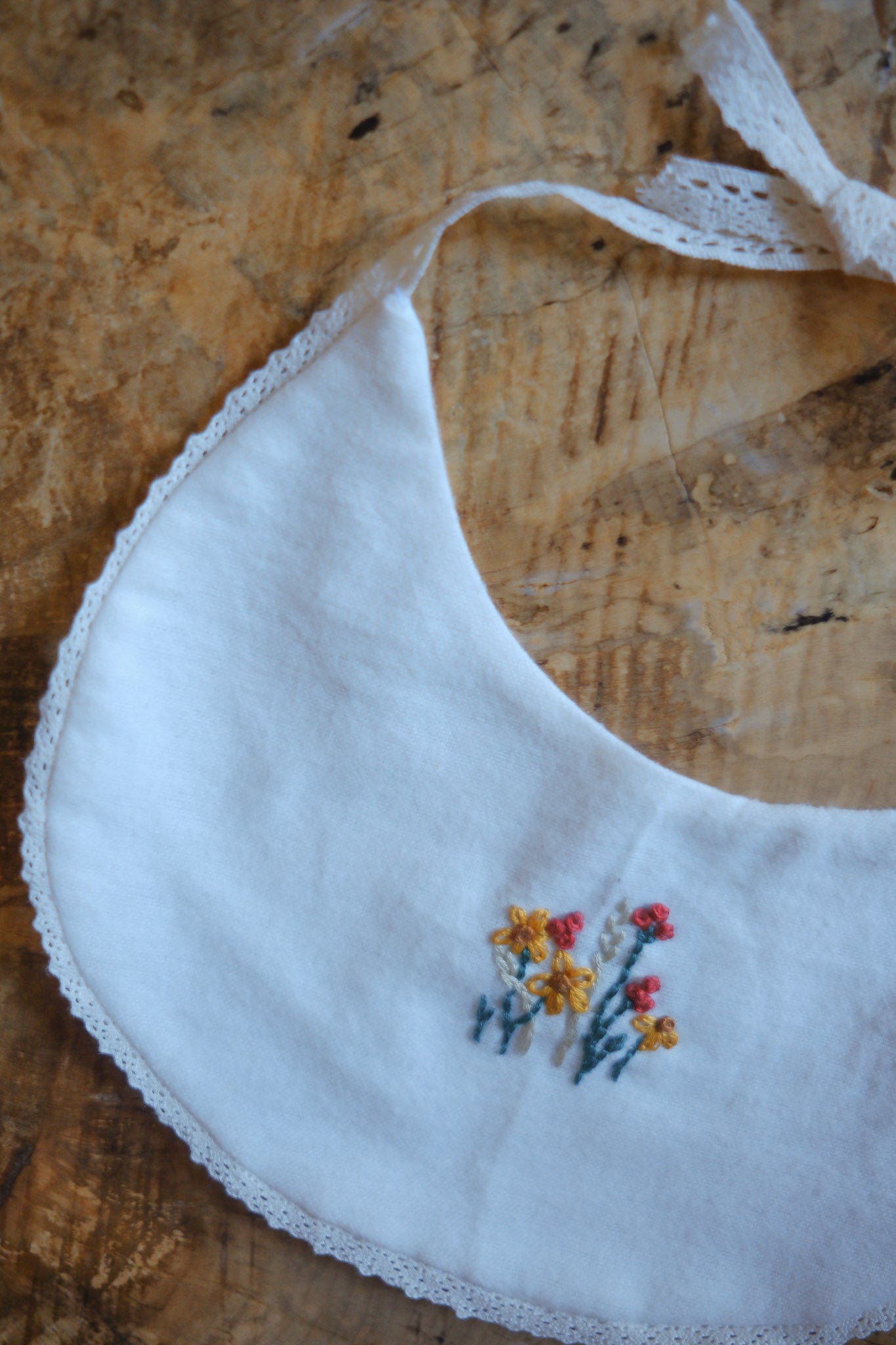 White Bib with Embroidered Wildflowers